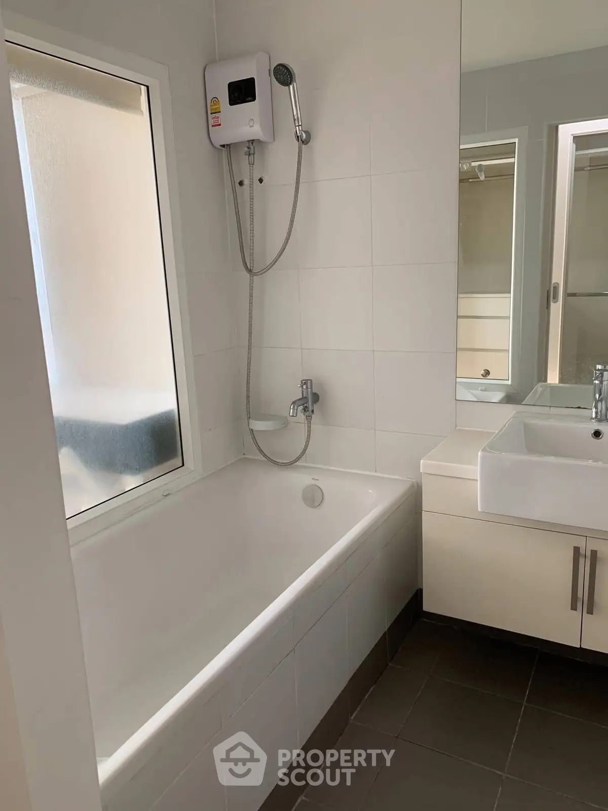 Modern bathroom with bathtub and sleek fixtures in a contemporary home.