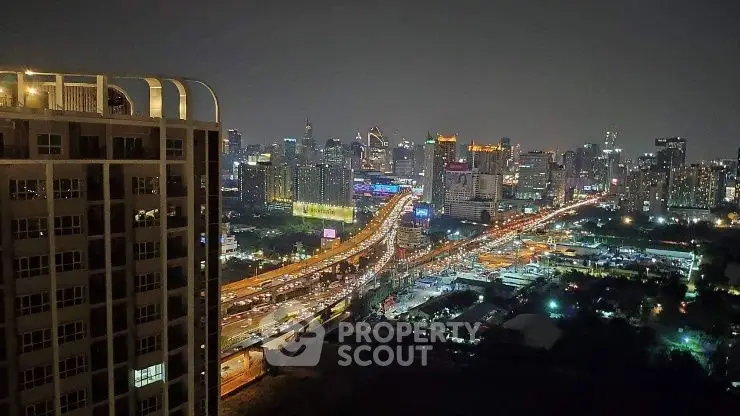 Stunning cityscape view from high-rise building at night with vibrant lights.