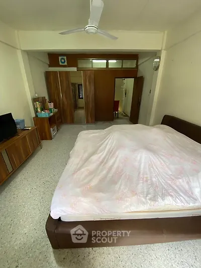 Spacious bedroom with modern furnishings and ample storage space