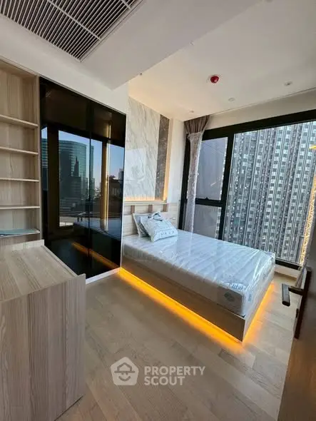 Modern bedroom with city view, featuring sleek design and ambient lighting in a high-rise apartment.