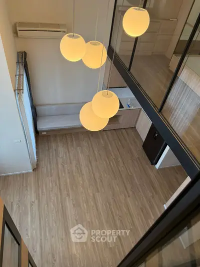 Modern loft-style living room with high ceiling and elegant lighting