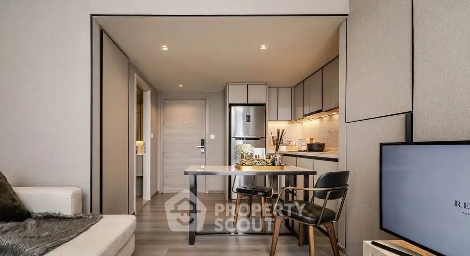 Modern open-plan kitchen and living area with sleek design and cozy ambiance.