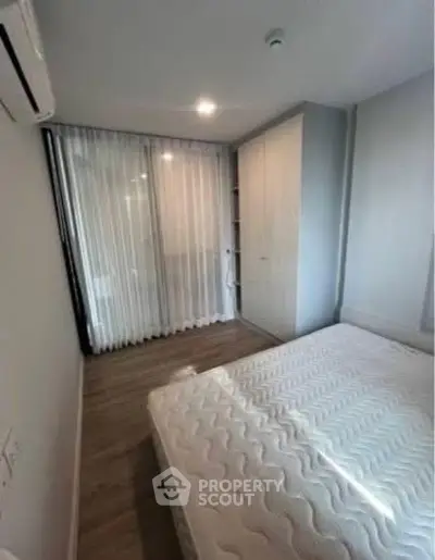 Cozy bedroom with modern design and ample natural light