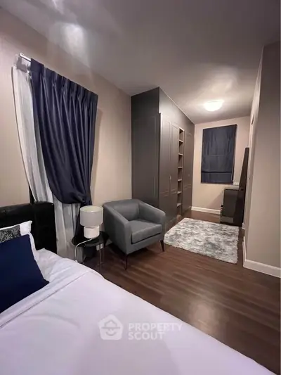 Stylish bedroom with modern decor and cozy seating area