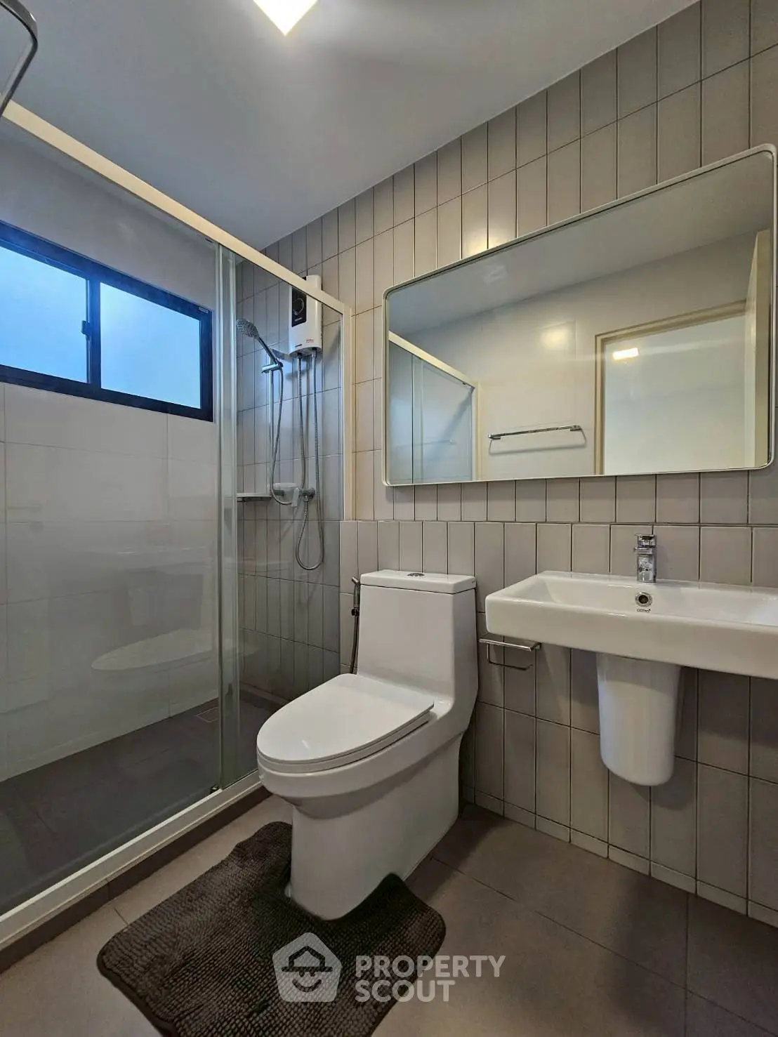 Modern bathroom with sleek fixtures and glass shower enclosure