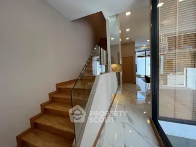 Modern interior with wooden staircase and marble flooring in a luxurious home