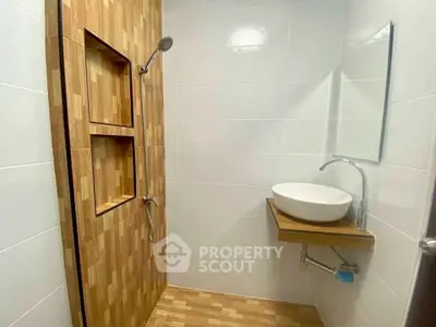 Modern bathroom with wooden accents and sleek fixtures