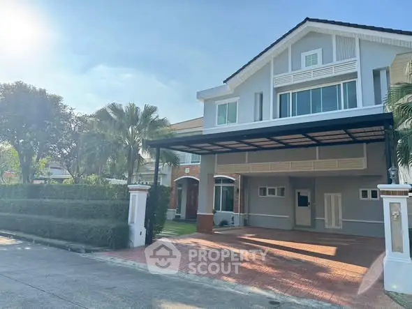 Charming suburban home with spacious driveway and lush greenery, perfect for family living.