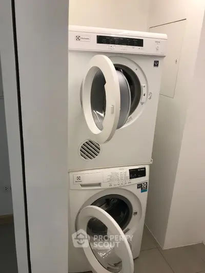Modern laundry area with stacked washer and dryer in a compact space.