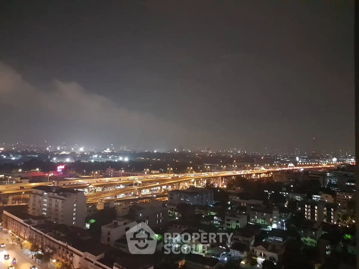Stunning cityscape night view from high-rise building, showcasing vibrant urban lights and expansive skyline.