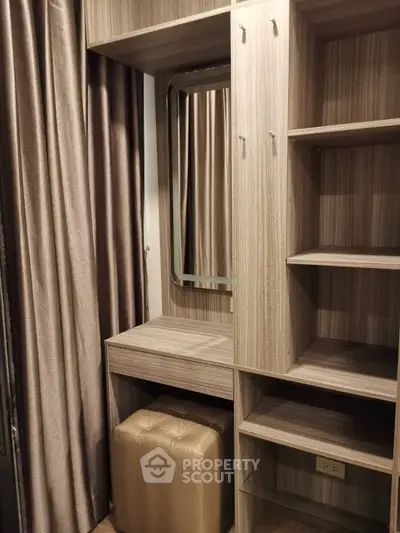 Elegant built-in wardrobe with mirror and shelves in modern apartment