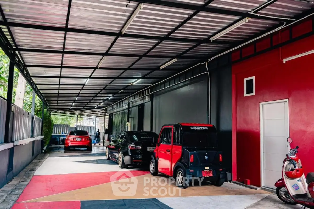 Spacious covered parking area with modern design and multiple vehicles parked.