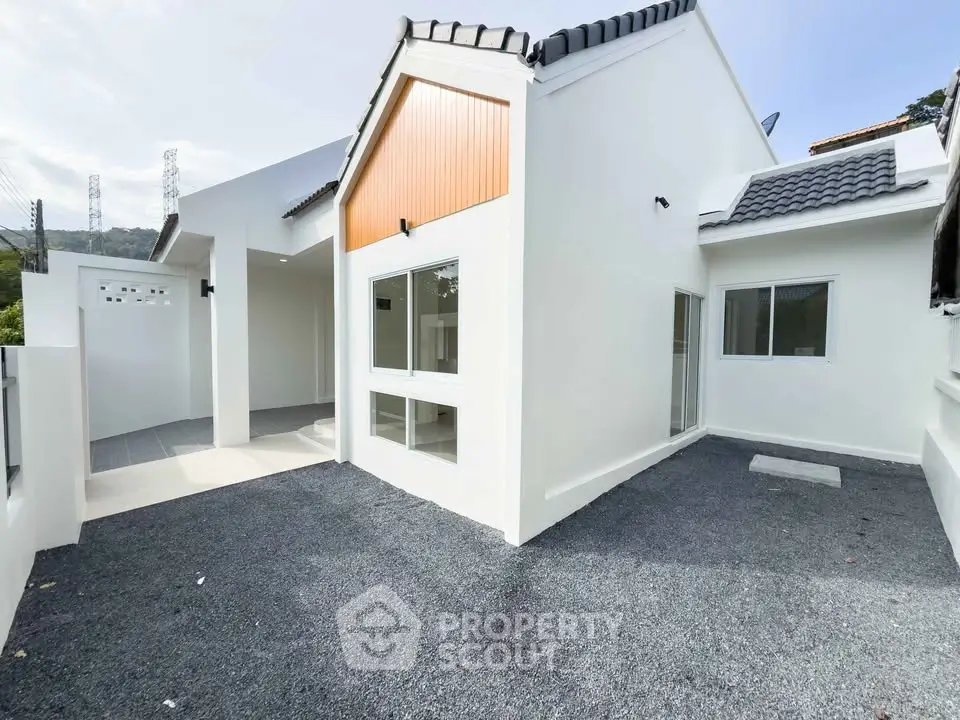Modern white house exterior with clean lines and spacious driveway