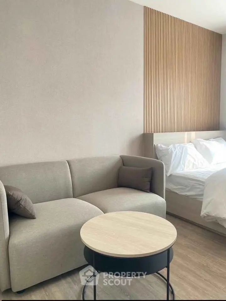 Modern bedroom with cozy sofa and stylish wooden accents