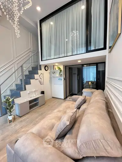 Modern loft-style living room with high ceilings and elegant decor