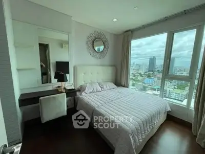 Luxurious bedroom with city view, elegant decor, and ample natural light.
