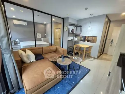 Modern open-plan living room with cozy brown sofa and stylish dining area in a contemporary apartment.