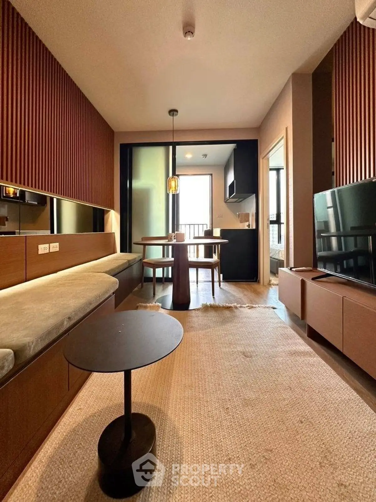 Modern living room with stylish decor and open layout, featuring a cozy seating area and dining space.