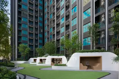 Modern high-rise building with landscaped garden and unique outdoor seating areas.