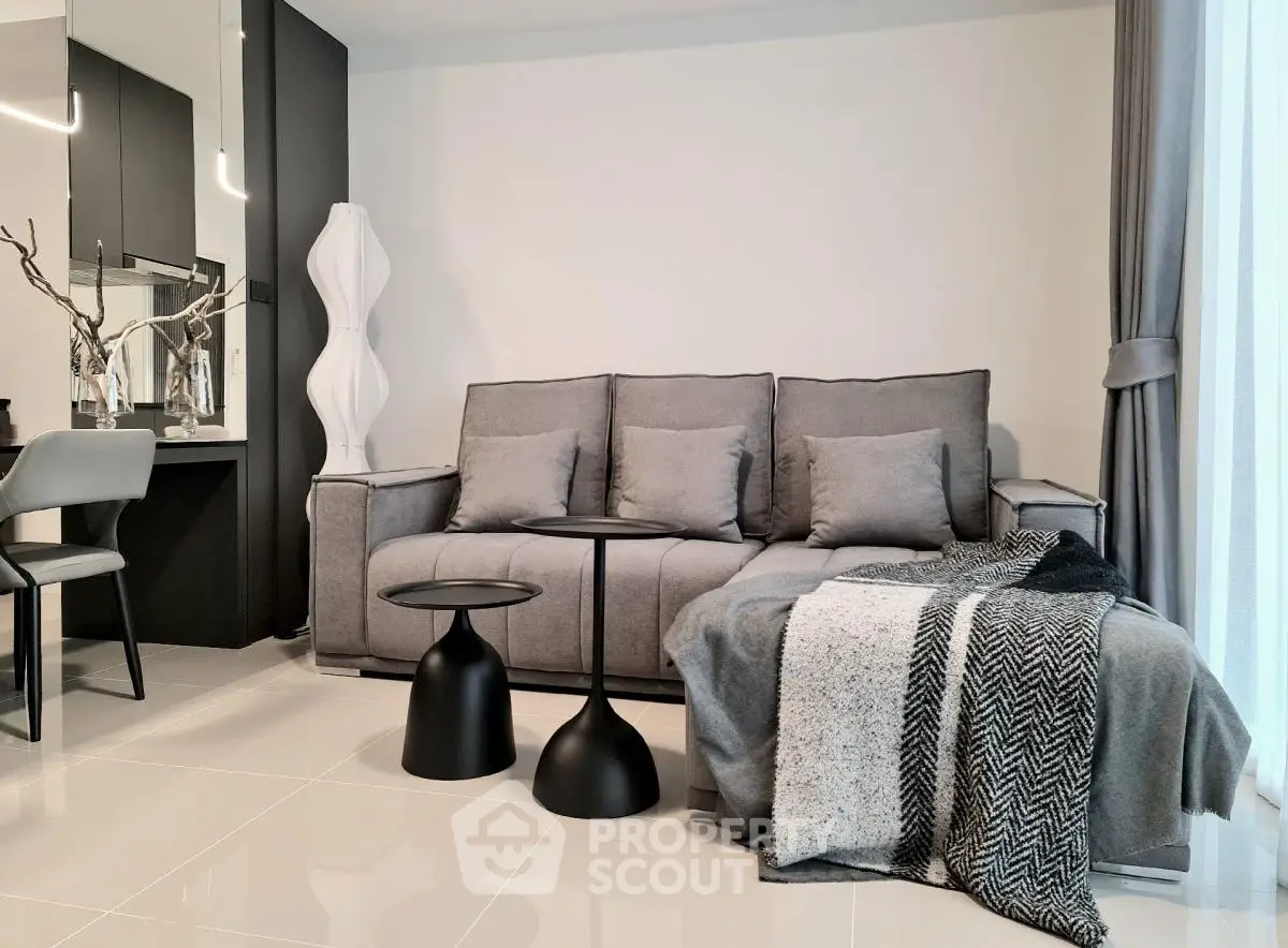 Modern living room with stylish gray sofa and chic decor