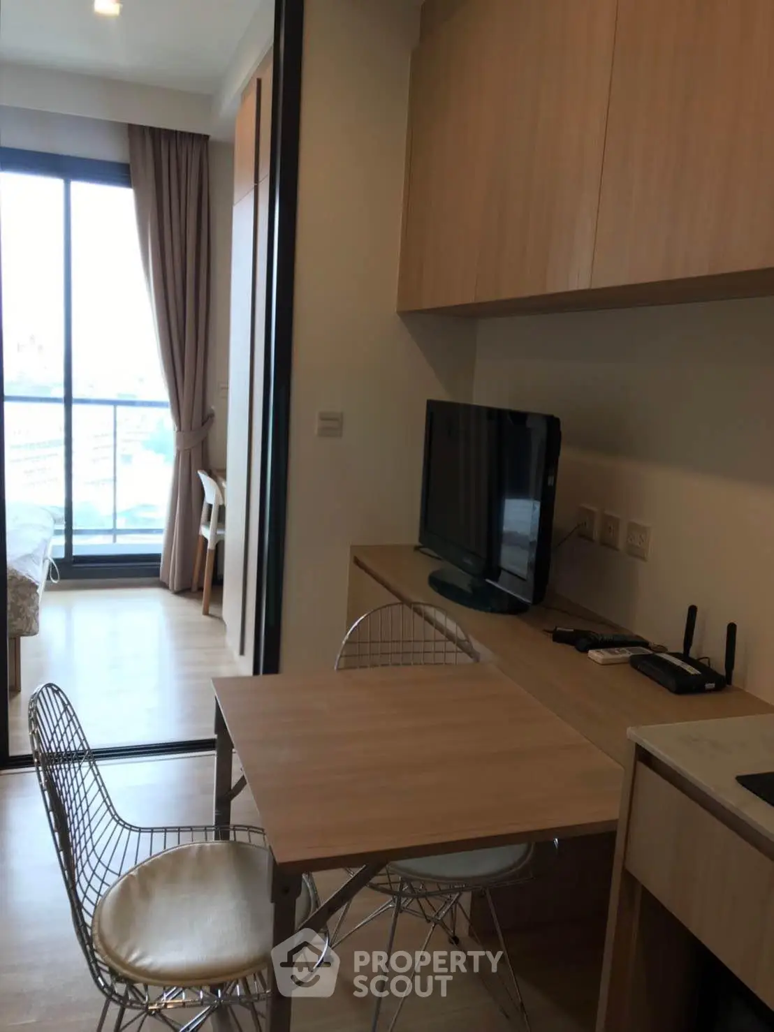Modern studio apartment with open layout and balcony view