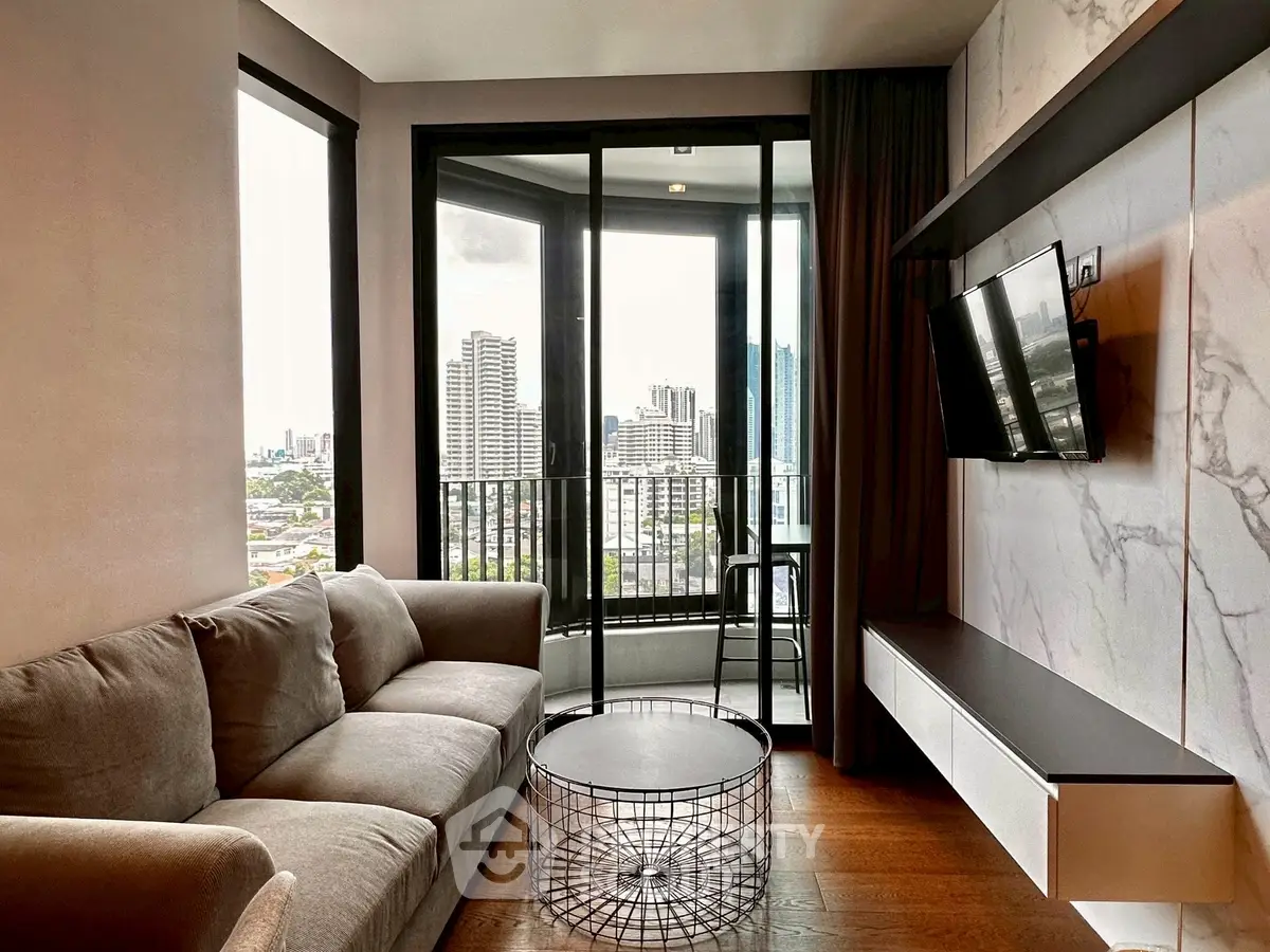 Modern living room with city view, stylish sofa, and sleek TV setup.