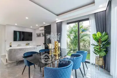 Luxurious modern living room with elegant dining area and garden view, featuring stylish blue chairs and glass table.