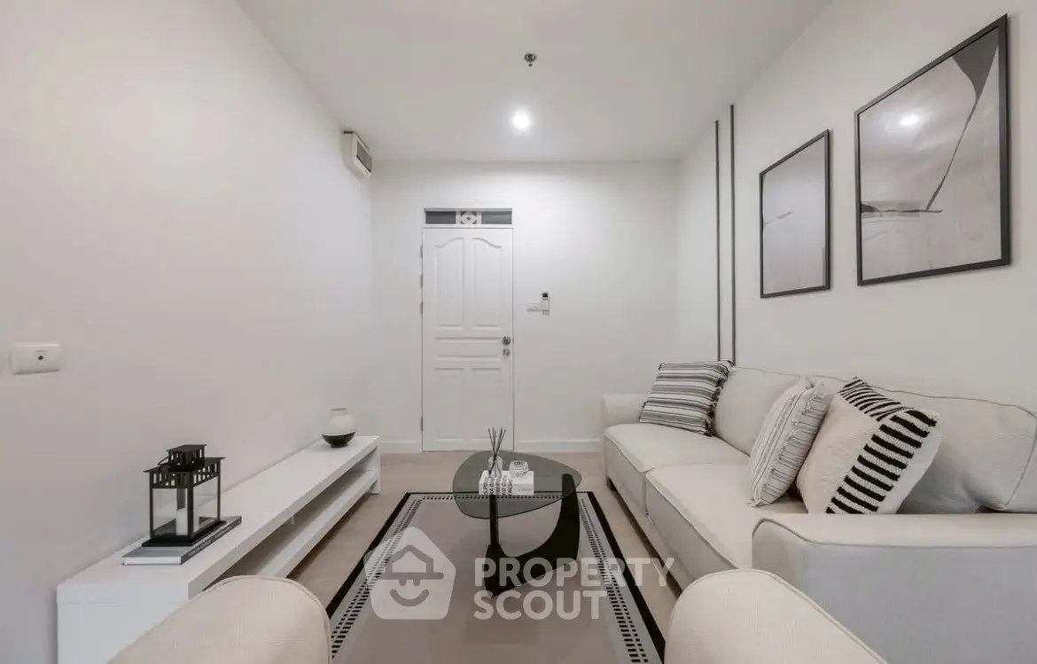 Modern living room with stylish decor and neutral tones, featuring a comfortable sofa and elegant wall art.