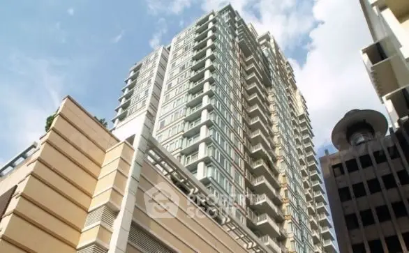 Stunning high-rise building with modern architecture and expansive windows in urban setting.