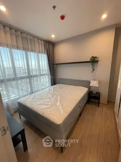 Modern bedroom with large window and minimalist decor