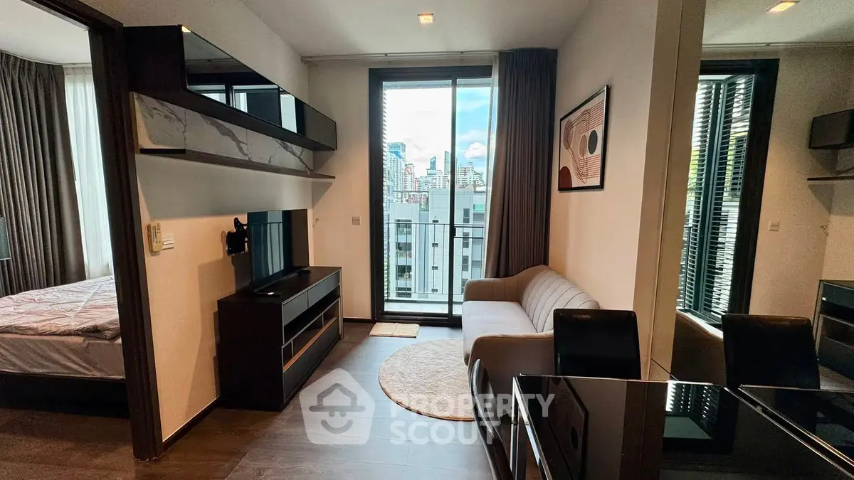 Modern apartment interior with stylish living room and city view from balcony.
