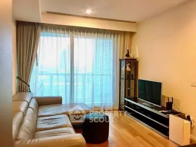 Spacious modern living room with large window and comfortable seating
