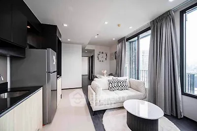 Modern living room with sleek design, large windows, and stylish furniture in a high-rise apartment.