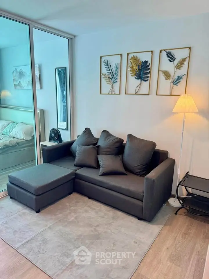 Modern living room with stylish decor and comfortable sofa in a cozy apartment setting.