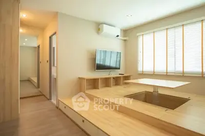 Modern minimalist living room with built-in wooden furniture and natural light