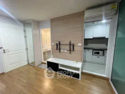 Modern apartment interior with wooden flooring and built-in kitchen appliances
