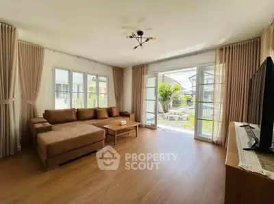 Spacious living room with large windows and modern decor