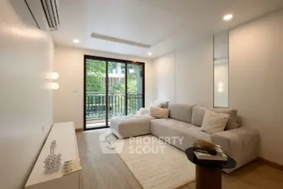 Modern living room with cozy sofa and balcony view in a stylish apartment.