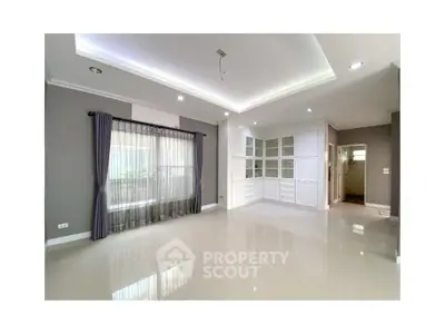 Spacious modern living room with elegant lighting and large windows