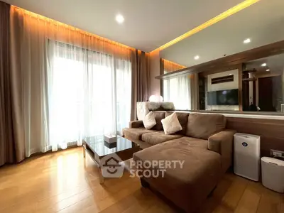 Spacious living room with modern decor and large windows for natural light.