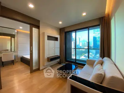 Modern living room with city view, featuring sleek furniture and large windows for natural light.