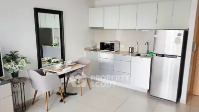 Modern kitchen with sleek cabinets and dining area in stylish apartment
