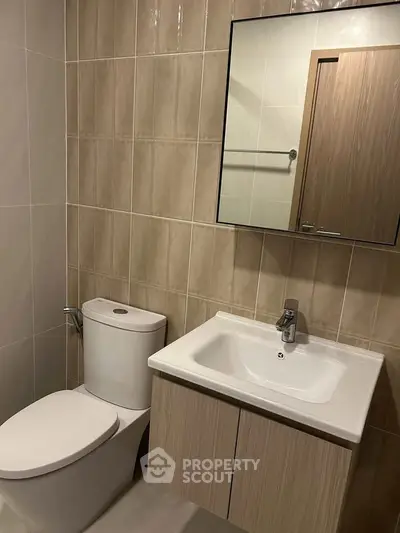 Modern bathroom with sleek fixtures and neutral tile design