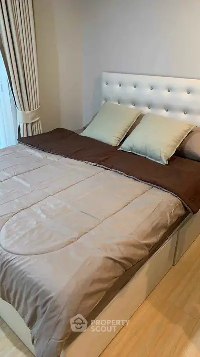 Cozy bedroom with elegant bed and soft lighting, perfect for relaxation.