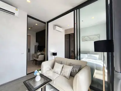 Modern living room with glass partition and cozy sofa in stylish apartment