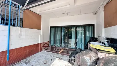 Spacious covered patio with sliding glass doors and tiled flooring