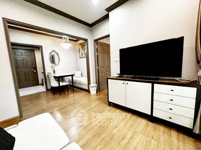 Modern living room with sleek TV stand and elegant dining area, perfect for urban living.