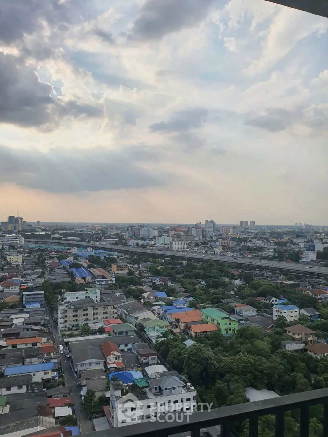 Stunning cityscape view from high-rise balcony with expansive skyline.