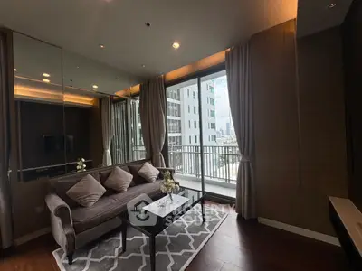 Modern living room with large windows and city view, featuring stylish decor and cozy seating area.