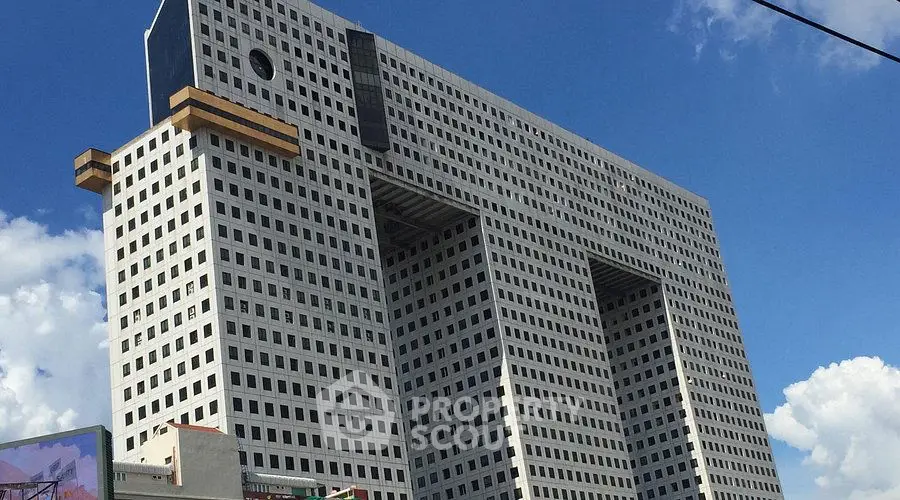 Modern architectural marvel with unique geometric design against a clear sky.